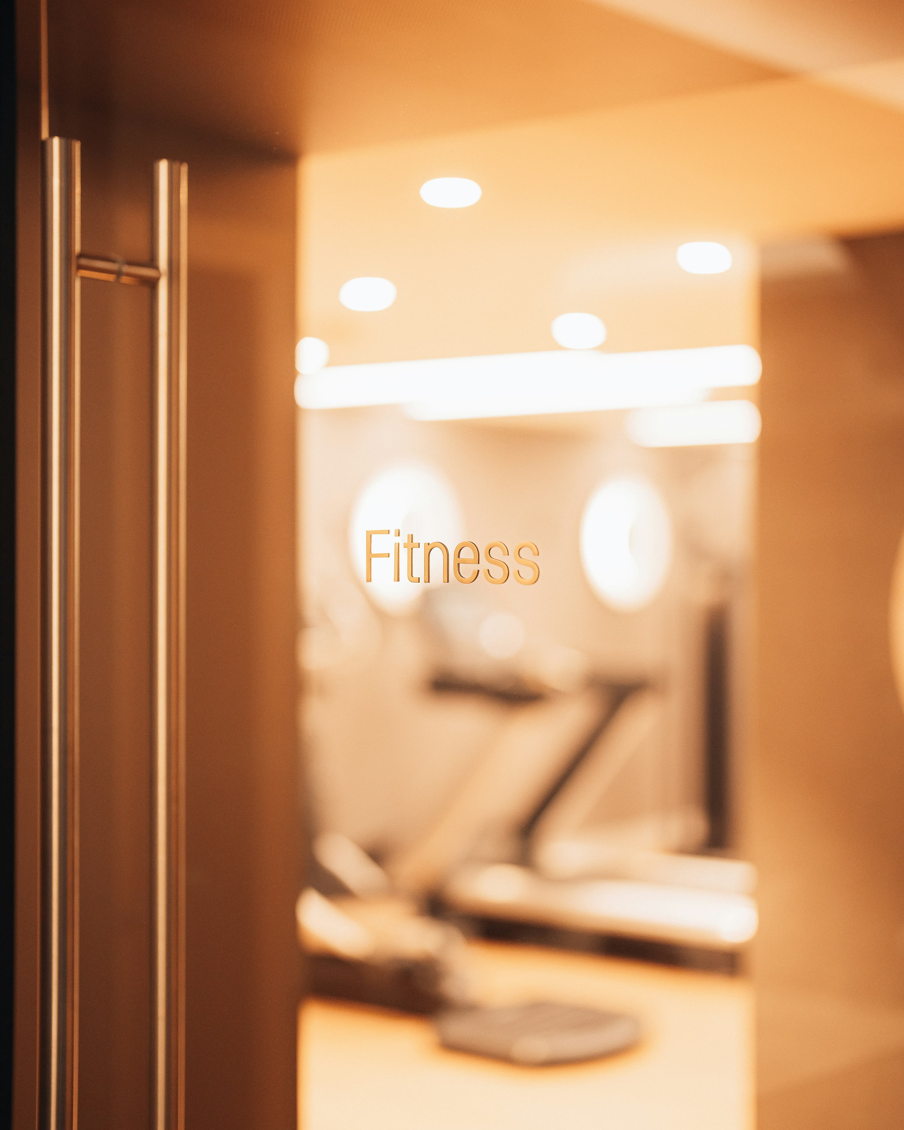 Gym lobby with members using a self-serve electrolyte and cold brew station.