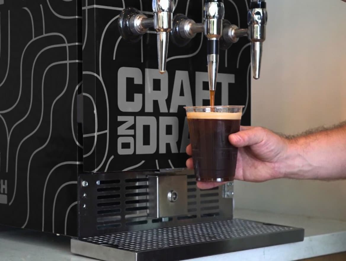 Resident pulling a nitro cold brew from the tap wall.