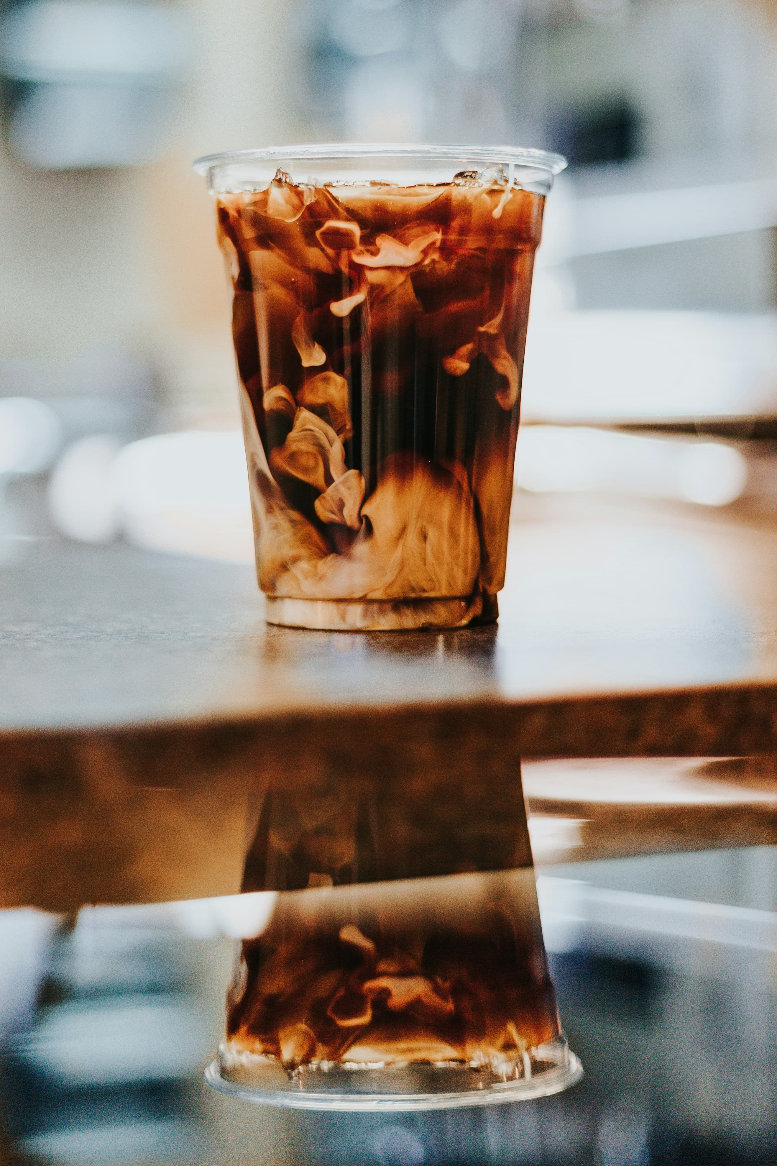 Stainless-steel tap tower pouring nitro cold brew in a modern apartment amenity lounge.